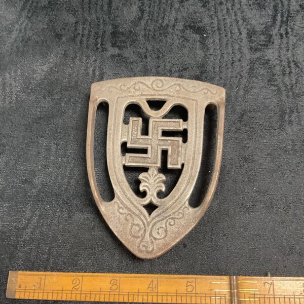 Vintage WWII German aluminium trivet with swastika emblem.