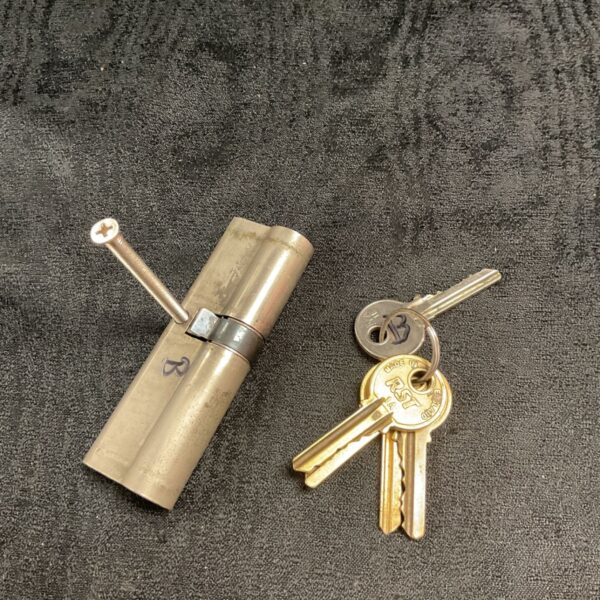 Vintage Yale door lock with five keys for security.