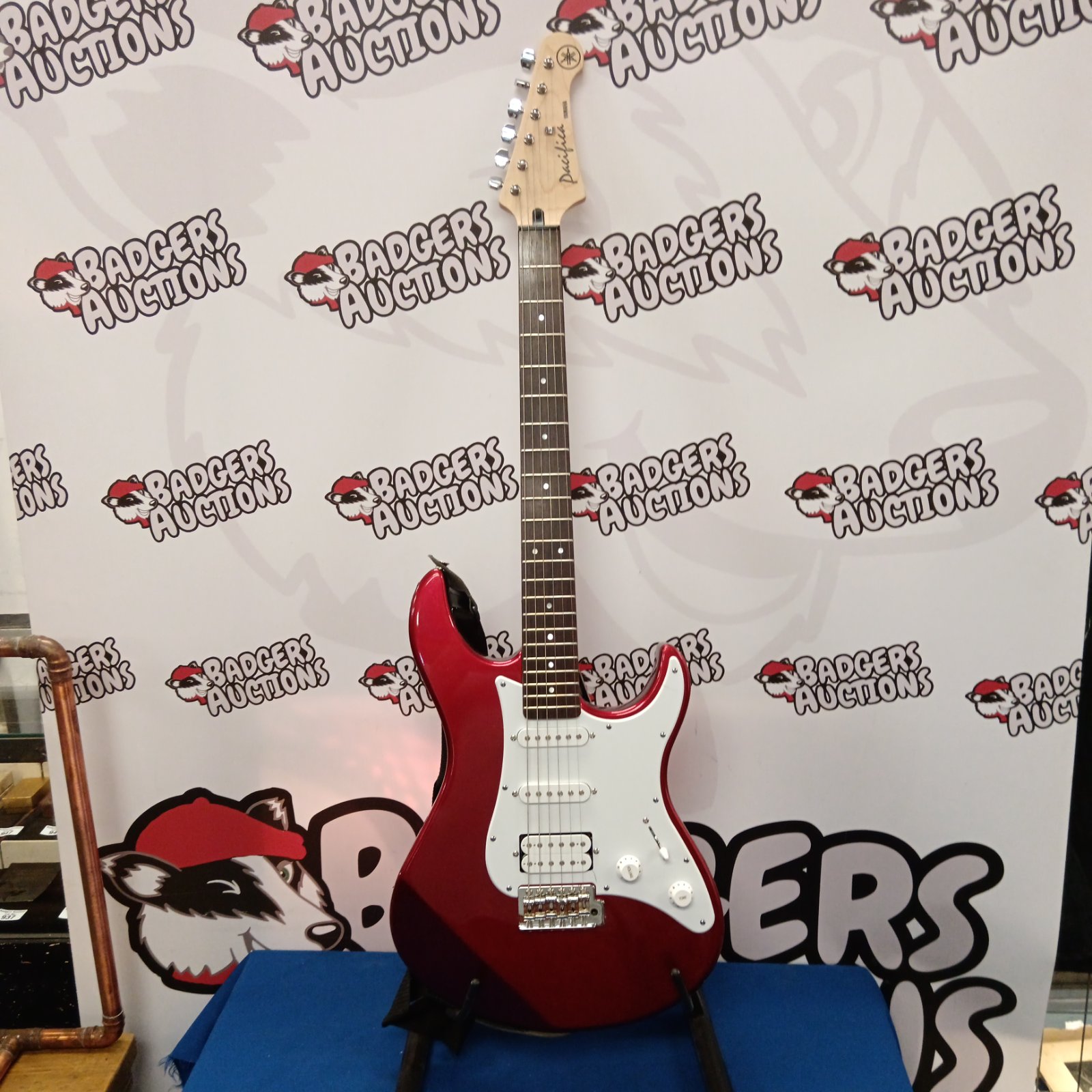 Red Yamaha Pacifica electric guitar, detailed studio shot.