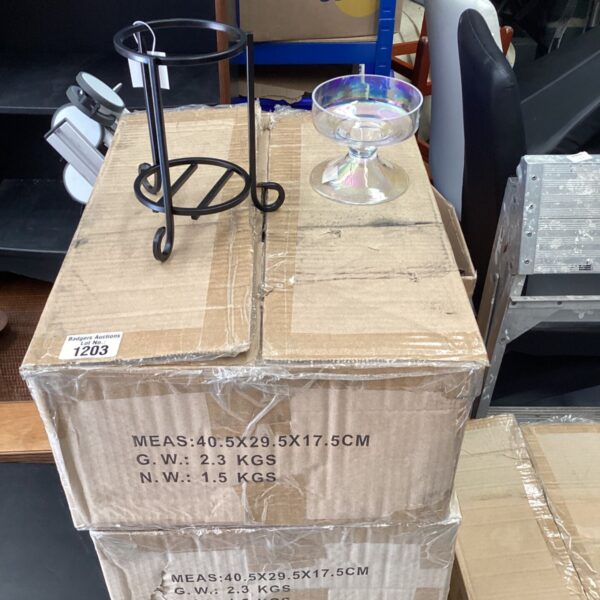 Stack of boxes containing Yankee Candle holders for home fragrance.