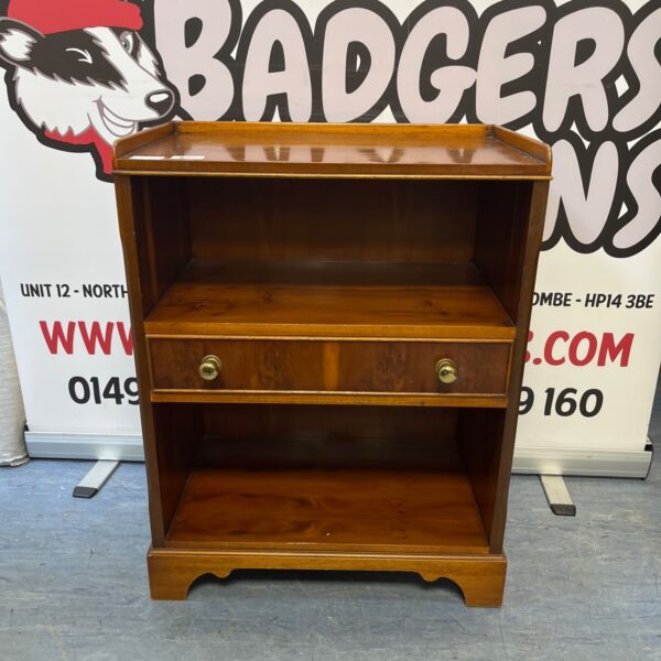 Vintage yew wood side table with two shelves and a drawer.
