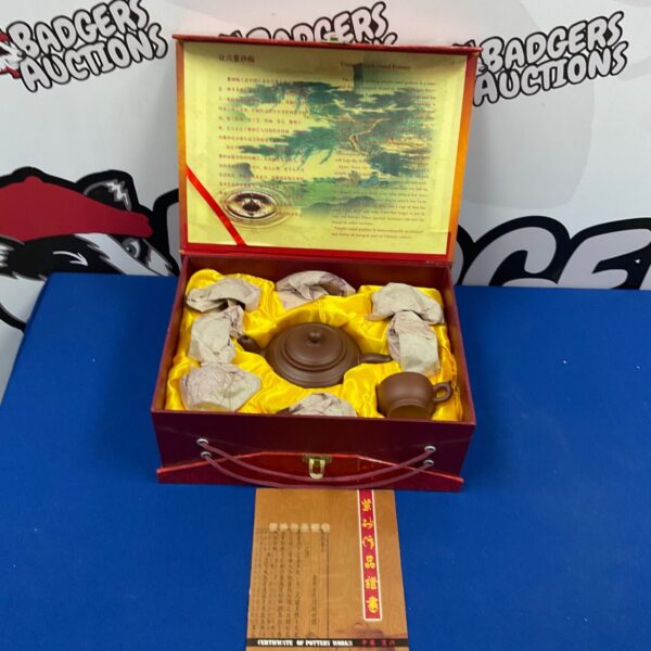 Vintage Yixing teapot set in original red box, a collectible tea set.