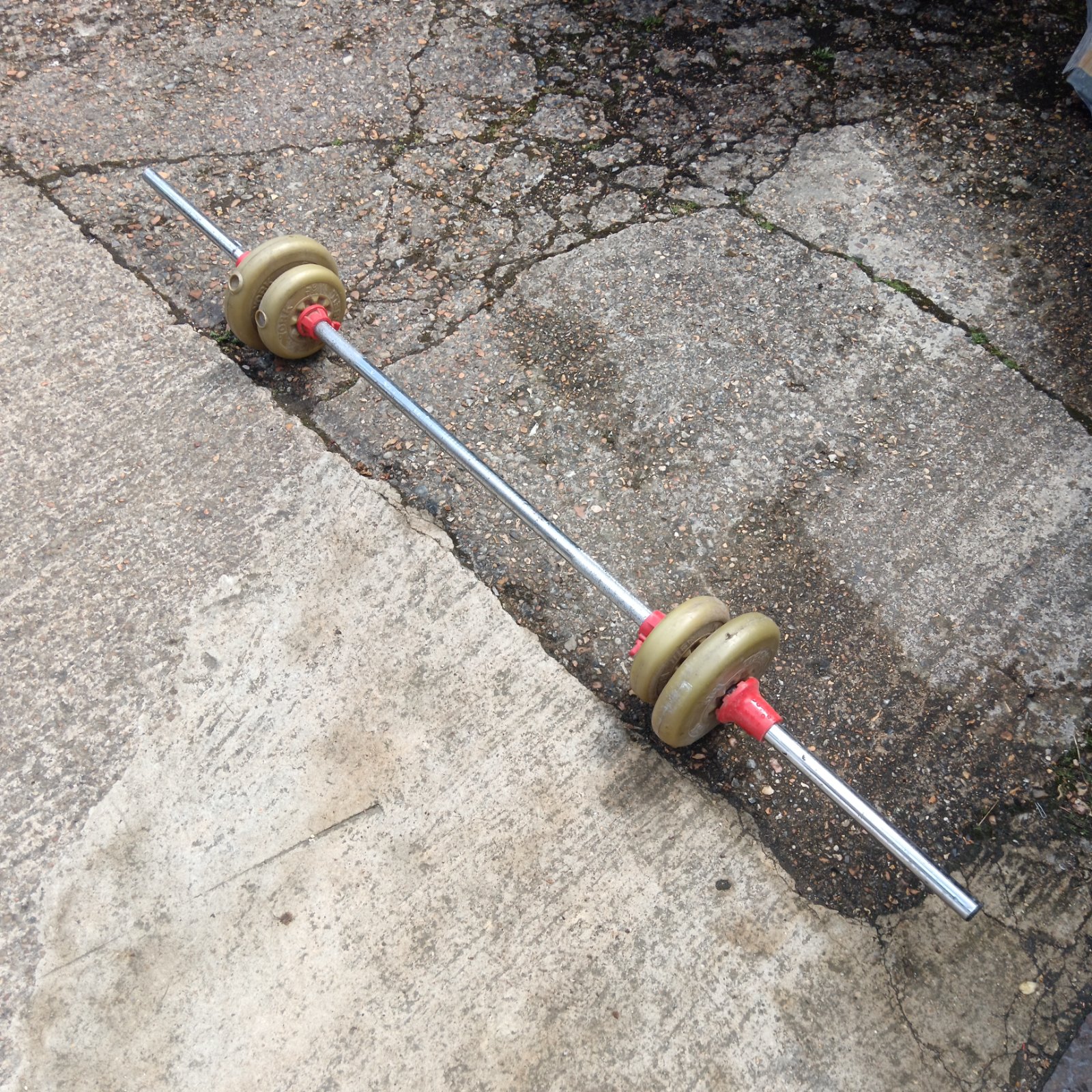 Vintage York dumbbells on a chrome barbell for fitness.