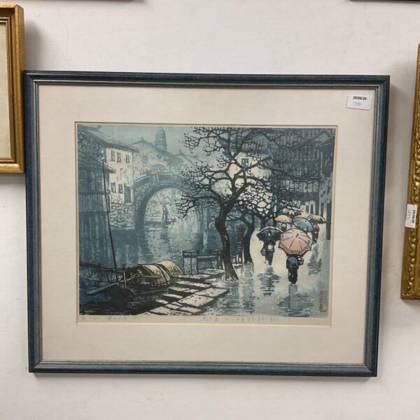 Framed Zhou Xing Hua print of figures by a canal in the rain.