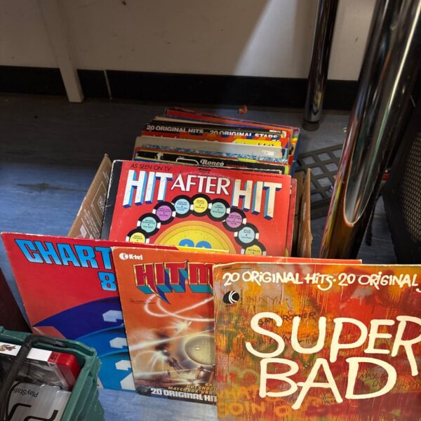 Stack of 12 inch vinyl records, chart hits collection.
