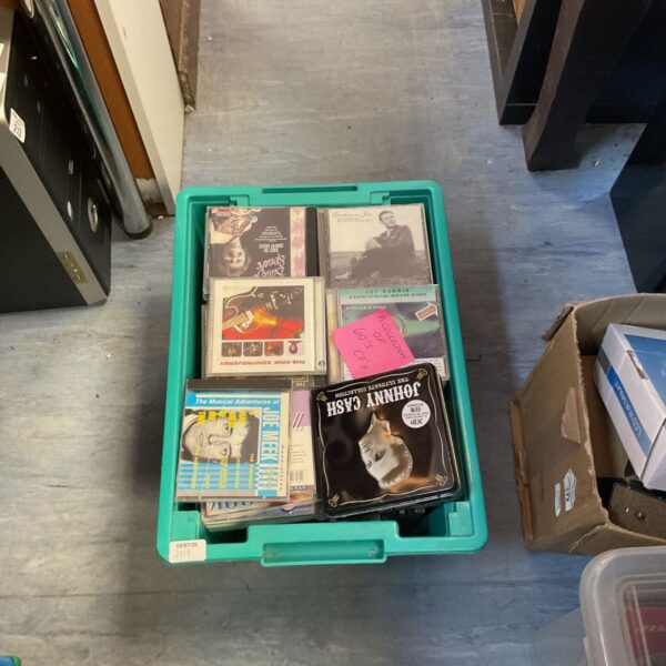 Collection of 1960s CDs in a plastic container.