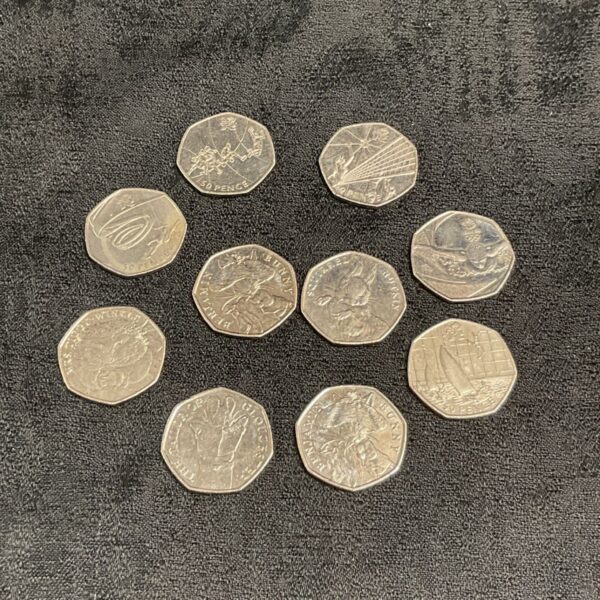 Collection of ten UK 50p coins including Olympic and Beatrix Potter designs.