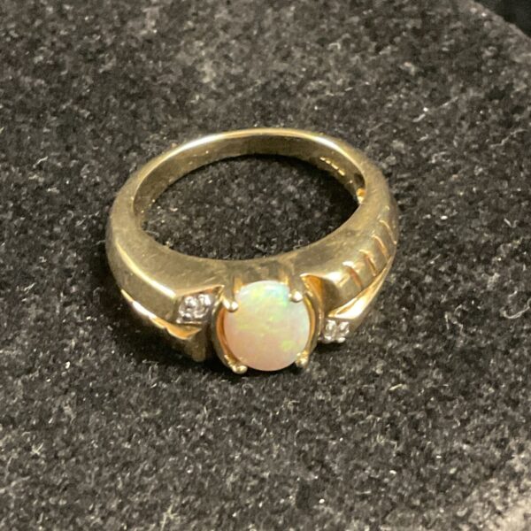 9ct gold ring with a vibrant opal and diamond accents.