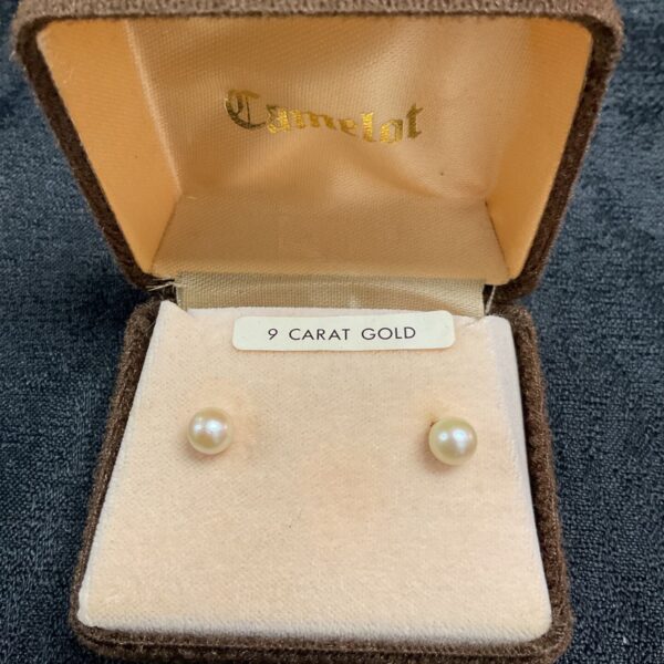 9ct gold pearl stud earrings displayed in a velvet box.