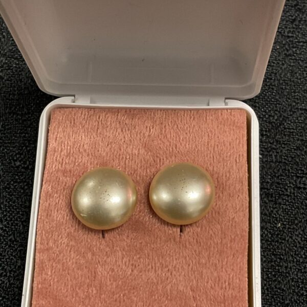 Close-up of 9ct gold pearl stud earrings showing detail.