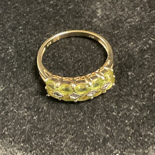 Close-up of a 9ct gold peridot and diamond ring.