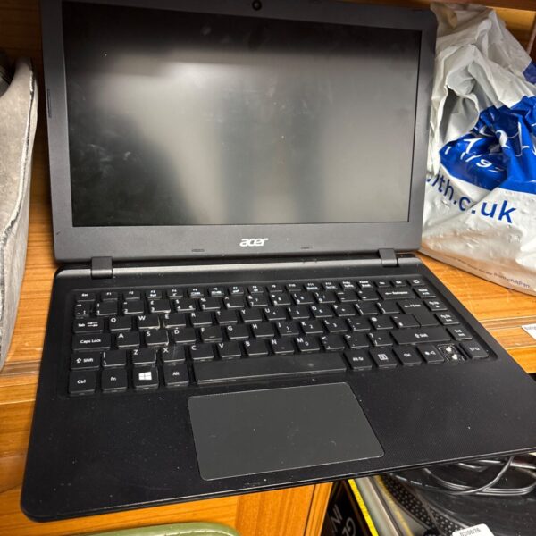 Used Acer Aspire ES1-332 laptop keyboard and casing detail.