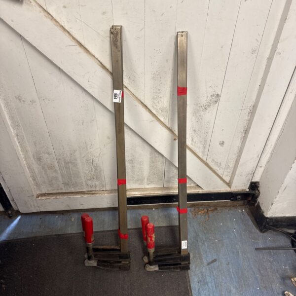 Pair of vintage adjustable metal clamps with red handles.