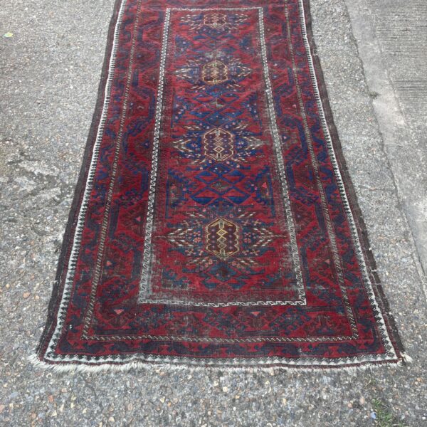 Vintage Afghan runner rug with red and blue geometric tribal design.