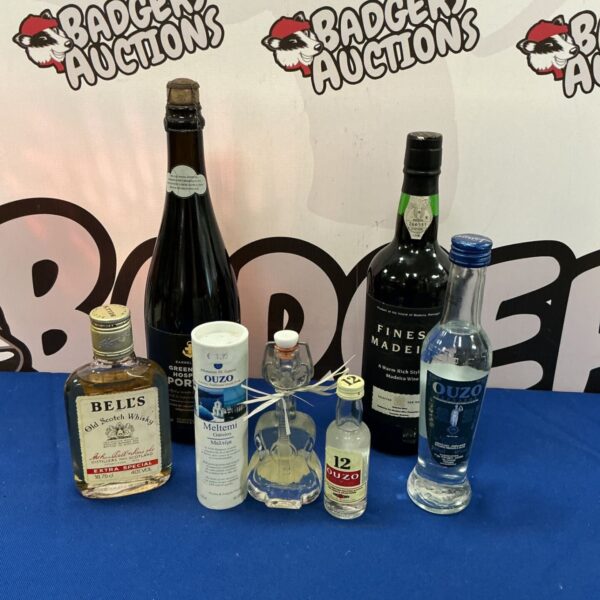 Vintage alcohol assortment including Madeira, Bells Whisky, and Ouzo bottles.