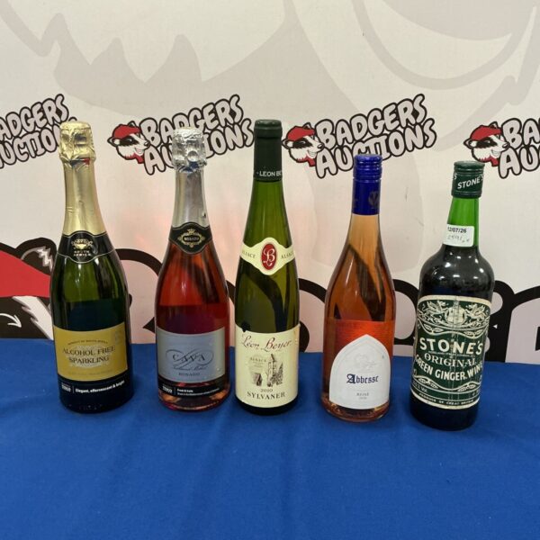 Mixed lot of five alcohol bottles including sparkling wine and Cava.