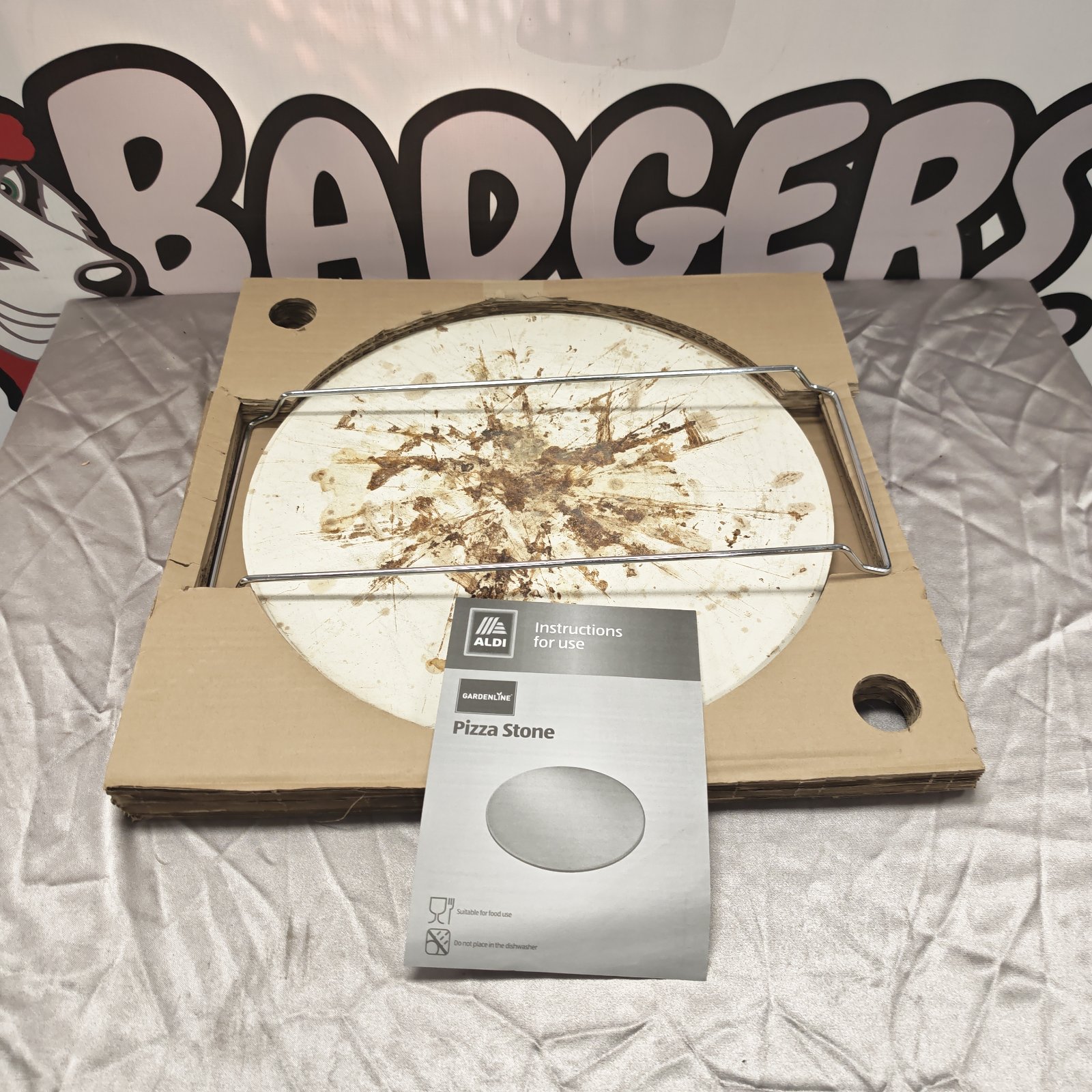 Round Aldi pizza stone showing signs of use.