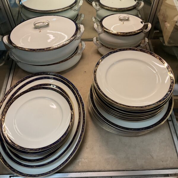 Alfred Meakin Bleu De Roi dinner plates stacked on a shelf.