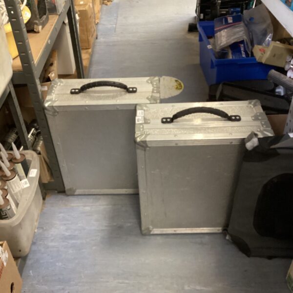 Two aluminium storage cases with carry handles, showing signs of wear.