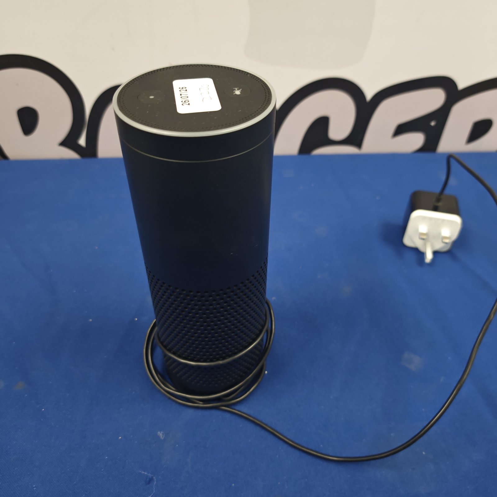 Used Amazon Echo smart speaker with power cable visible.