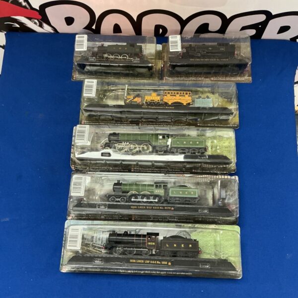 AmerCom model railway trains, including Stephenson’s Rocket, in packaging.