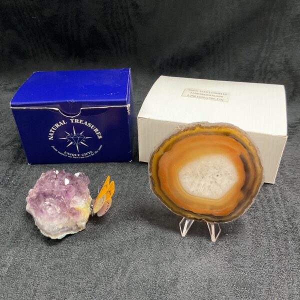 Amethyst crystal display with butterfly and agate slice.