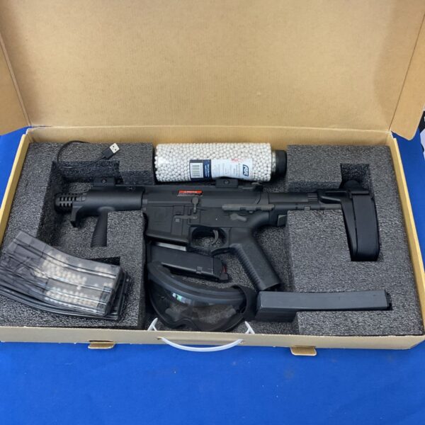 Amoeba airsoft gun with BB pellets and accessories displayed in a box.
