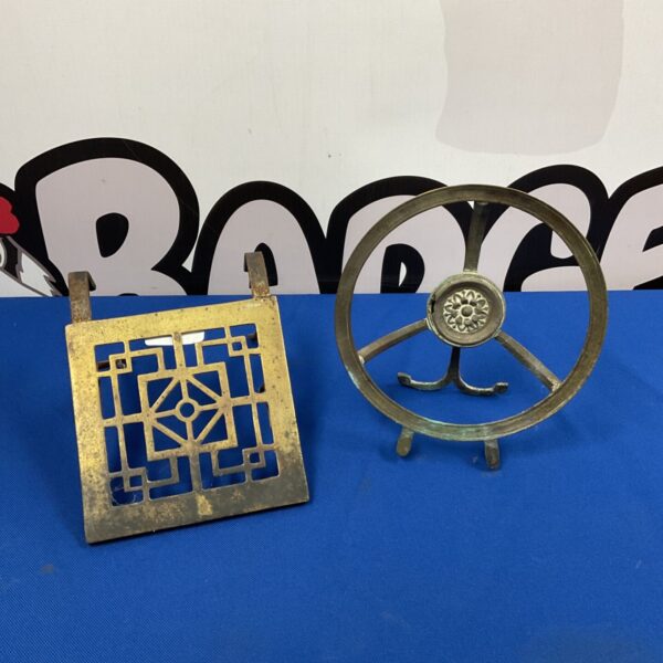 Antique brass and iron fireplace trivet with pierced design.