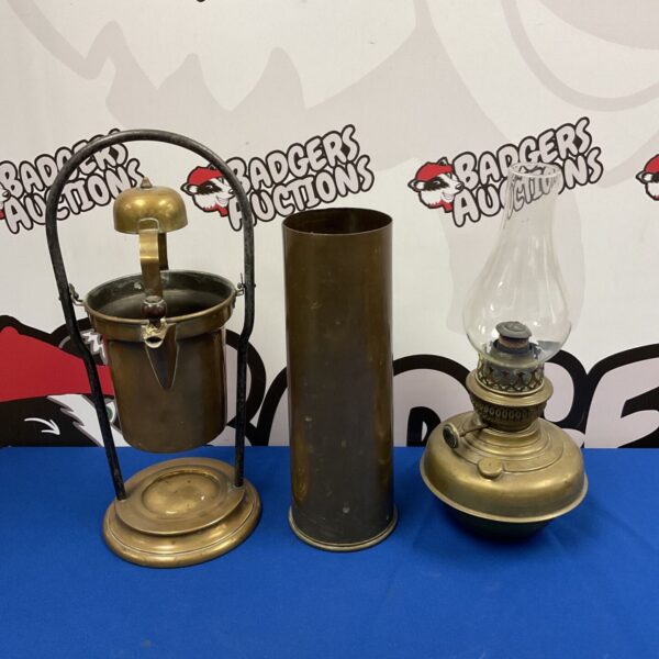 Antique brass spirit kettle and Wellington oil lamp with 1938 dated canon shell.