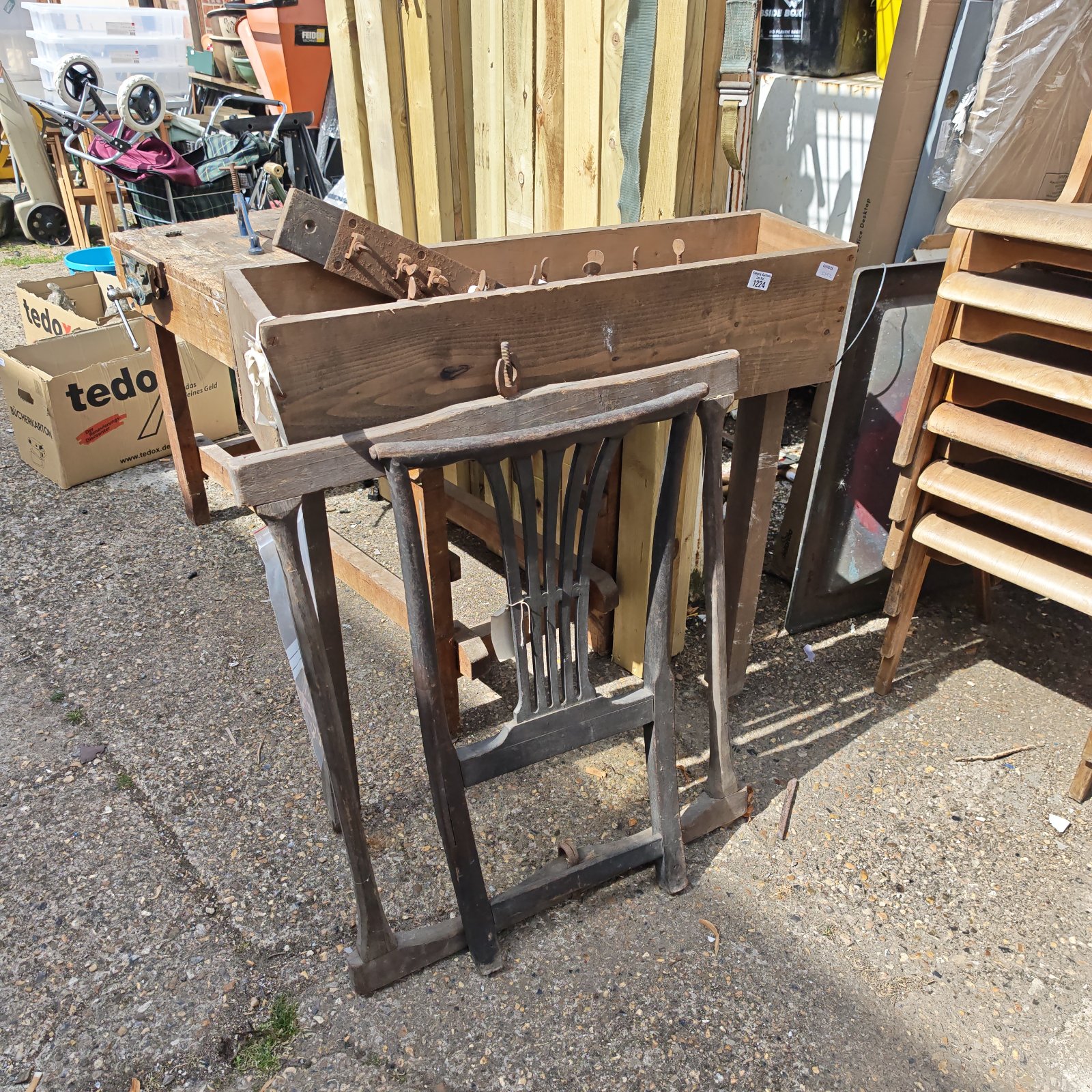 Antique chair making equipment with chair back and saw frame.