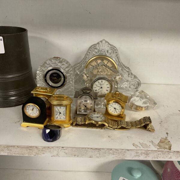 Antique clock collection featuring brass mantel clock and pocket watches.