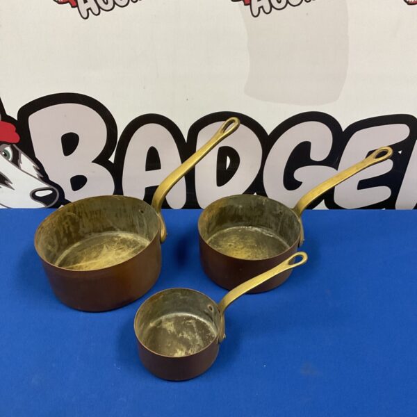Antique graduated copper saucepan set, vintage kitchenware.