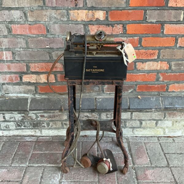 Antique Dictaphone recording machine with foot pedals, vintage office equipment.