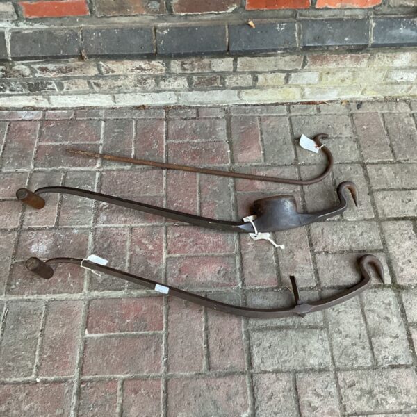 Antique furniture making tools with wooden handles and metal hooks.