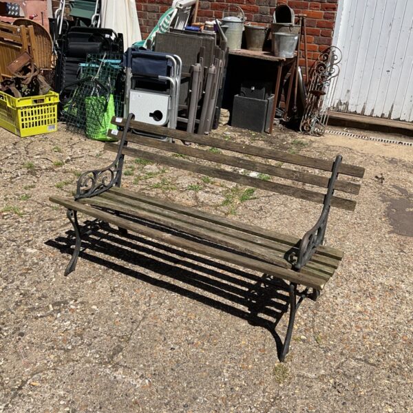 Antique garden bench with cast iron frame and weathered wood slats.