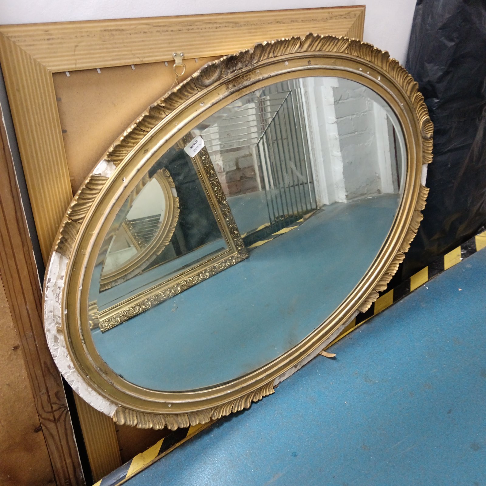 Antique gilt framed oval bevel edged mirror, 102cm x 79cm.
