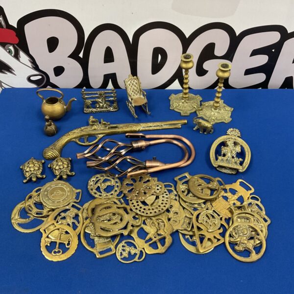 Antique horse brasses collection with door knocker and candlesticks.