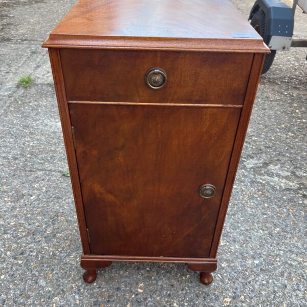 Antique mahogany bedside cabinet with brass hardware.