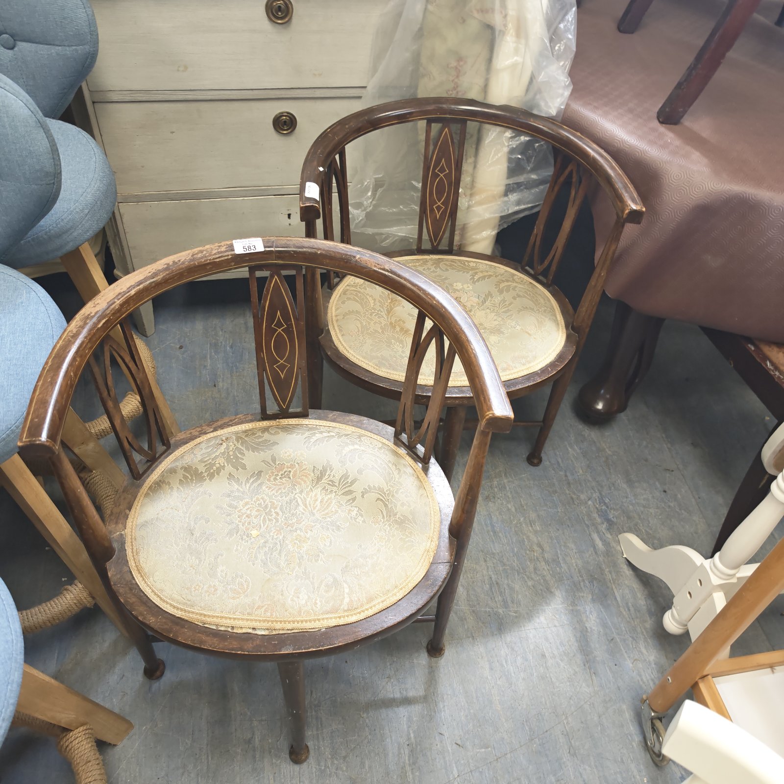 Antique mahogany parlour chairs with patterned seats and carved details.