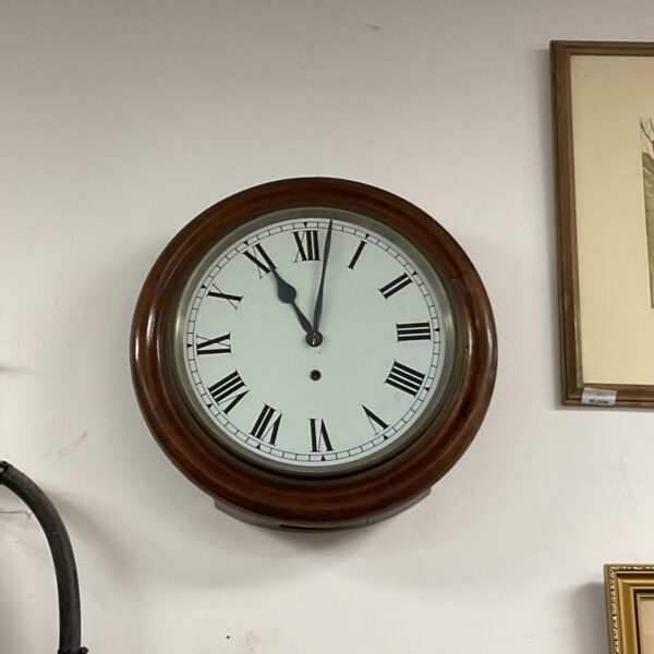 Antique mahogany school clock with Roman numerals on a white dial.