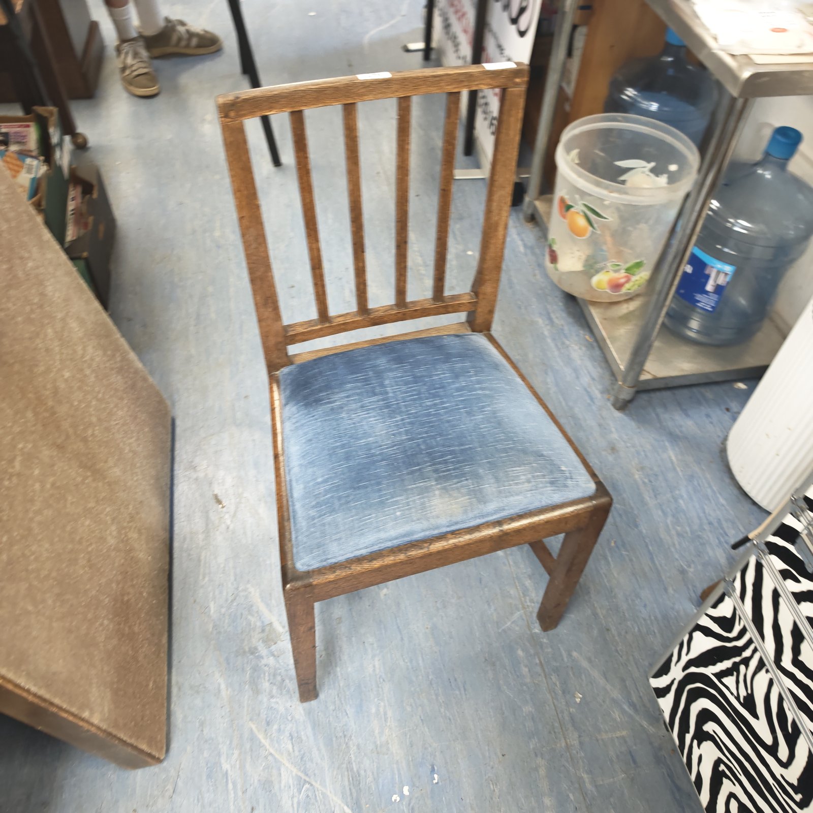 Antique oak bedroom chair with faded blue upholstery.