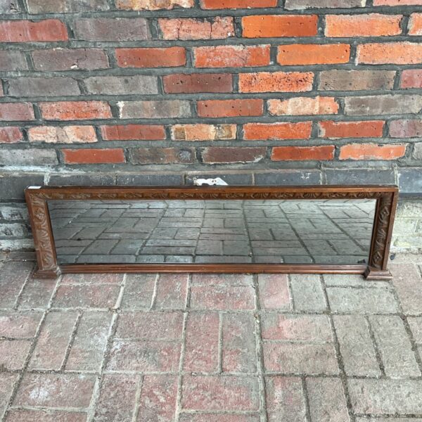 Antique oak mantle mirror with bevelled glass and carved frame.