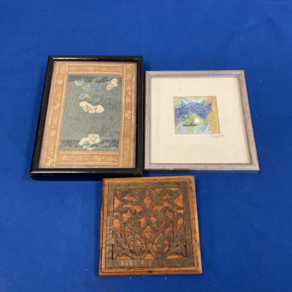 Antique silk embroidery with vibrant floral design in a decorative frame.