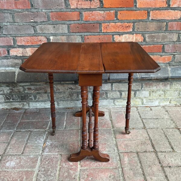 Antique mahogany Sutherland table with dropleaf extensions.