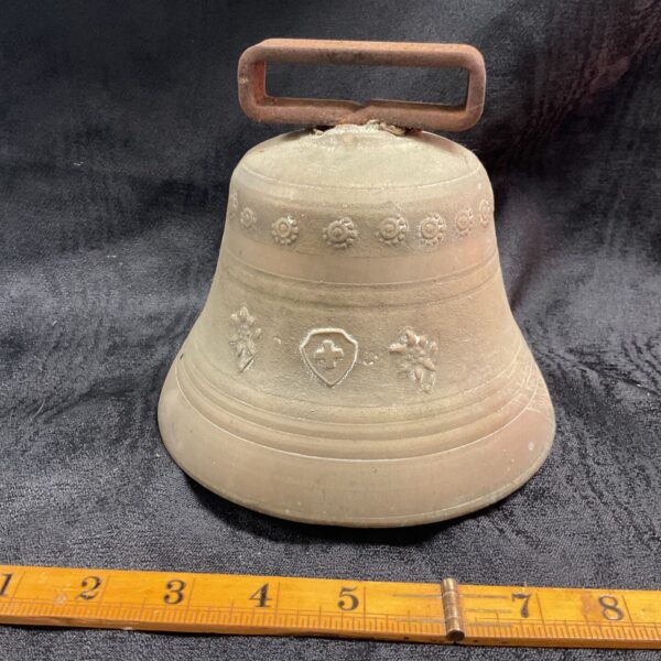 Antique Swiss cow bell with floral embossing, early 20th century.