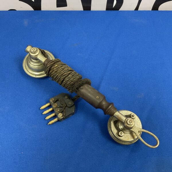 Antique Bakelite telephone handset with coiled cord.