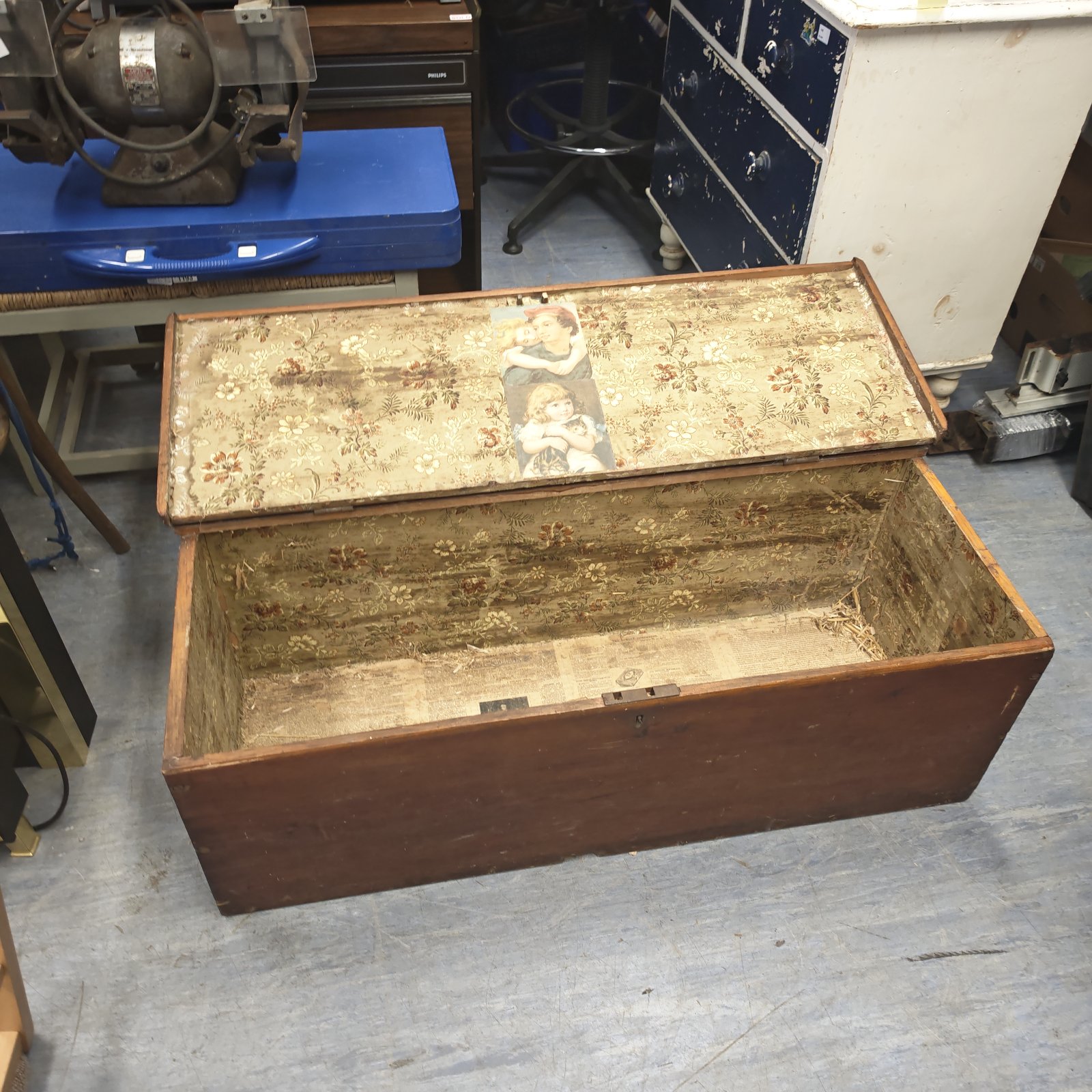 Antique trunk interior with floral patterned lining.