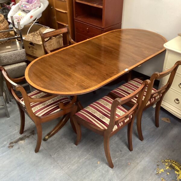 Antique walnut dining set with four chairs in a room.