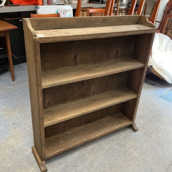 Antique wooden bookshelf with three shelves, vintage farmhouse style.