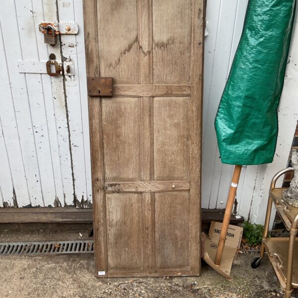 Antique wooden door from Wycombe museum with aged patina.
